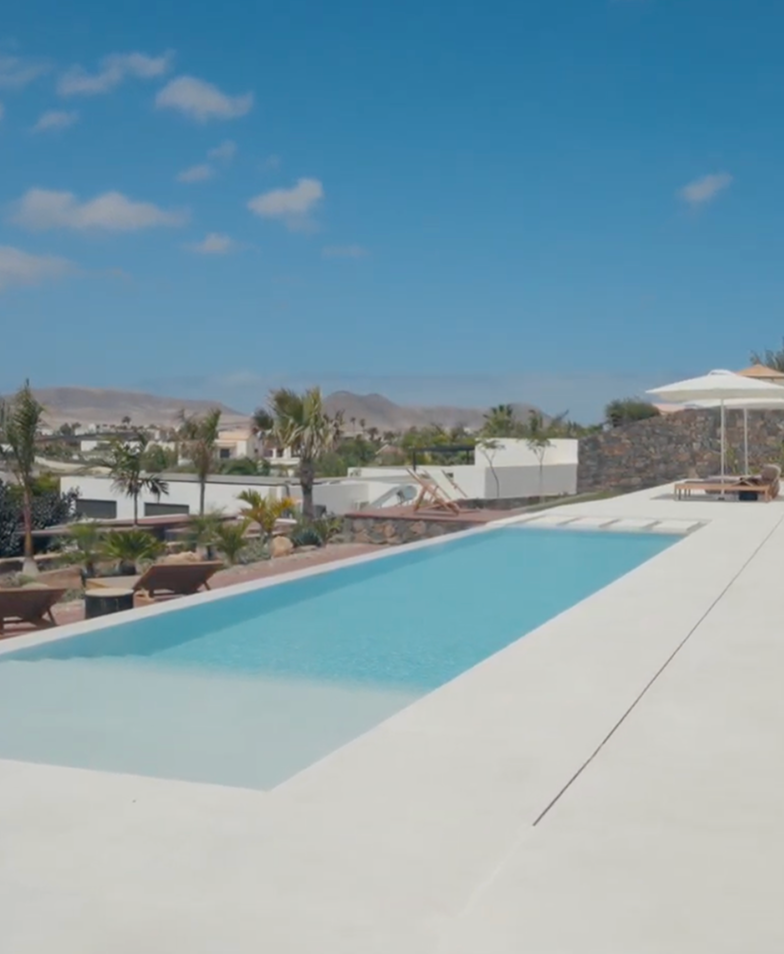 Modern infinity pool overlooking desert landscape.