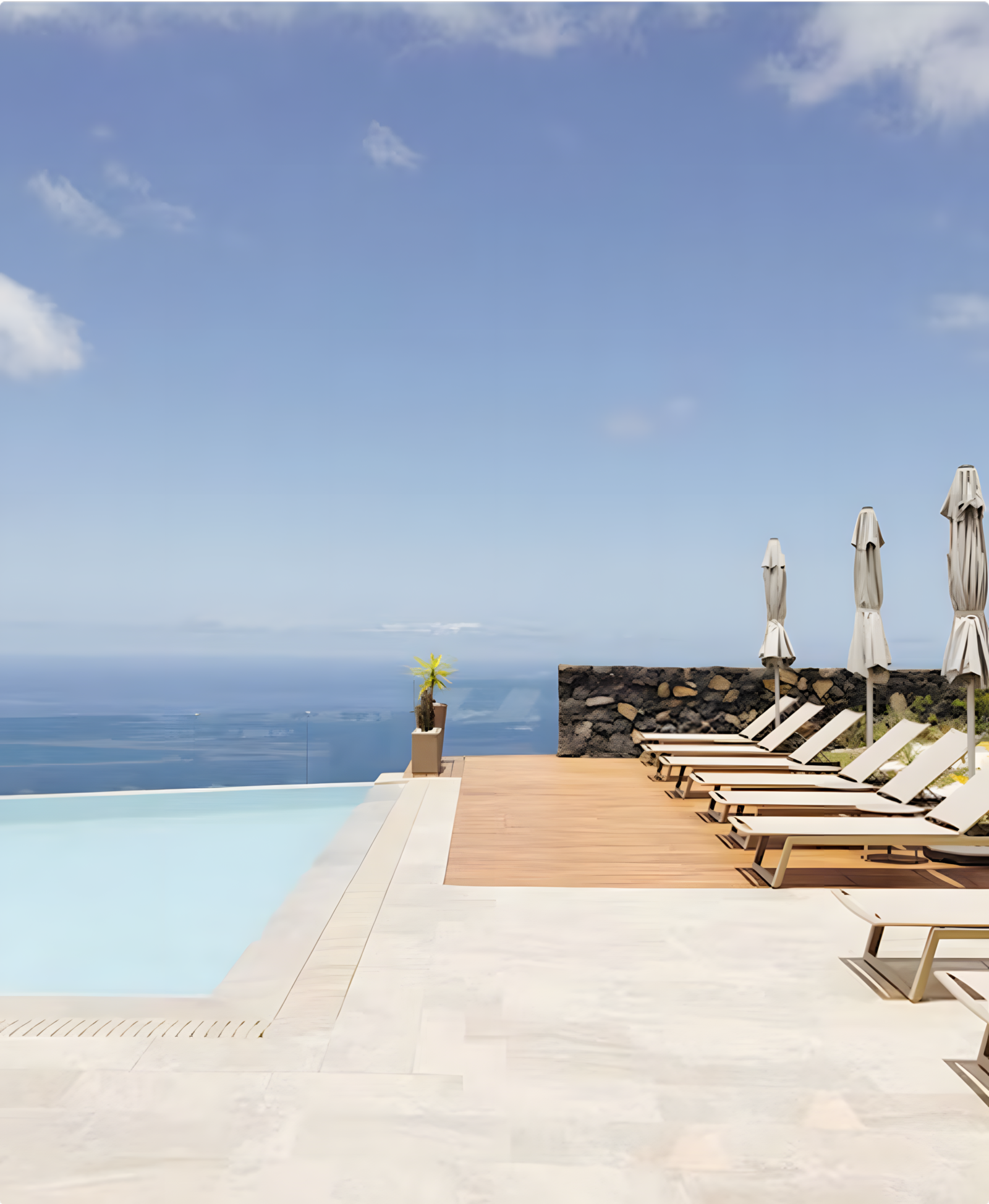 AURA Partners: Infinity pool, lounge chairs, and ocean view.