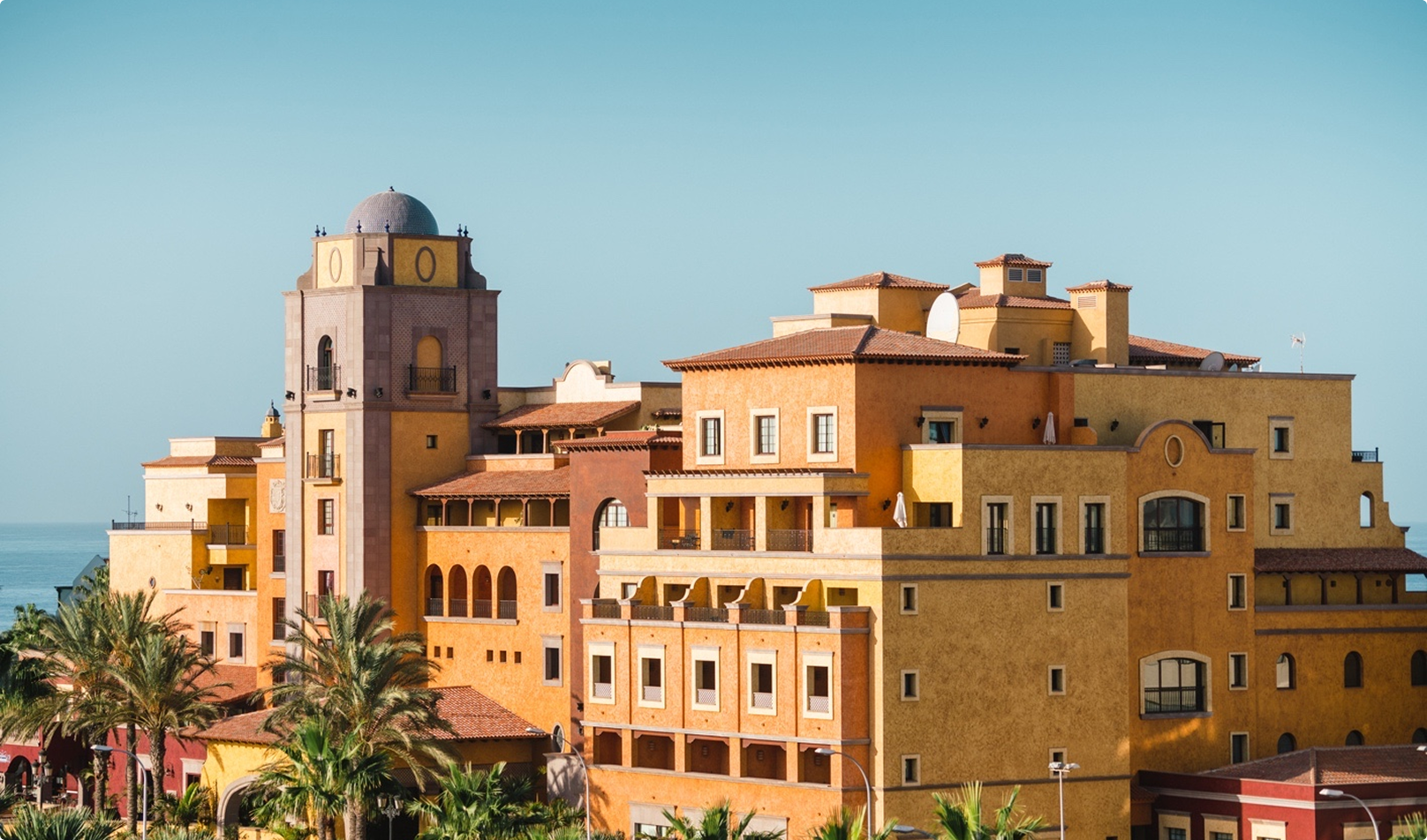 AURA Partners Villa Cortes Building: Spanish-style architecture, ocean view.