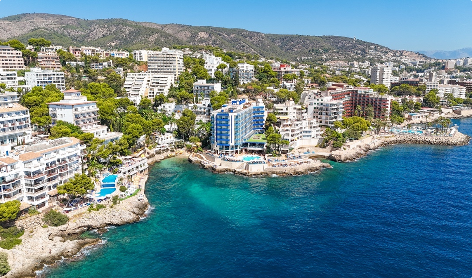 Playa Marina Hotel, AURA Partners: coastal resort aerial view.