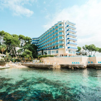 La Palma Hotel beachfront resort: Blue building, turquoise water, beach.